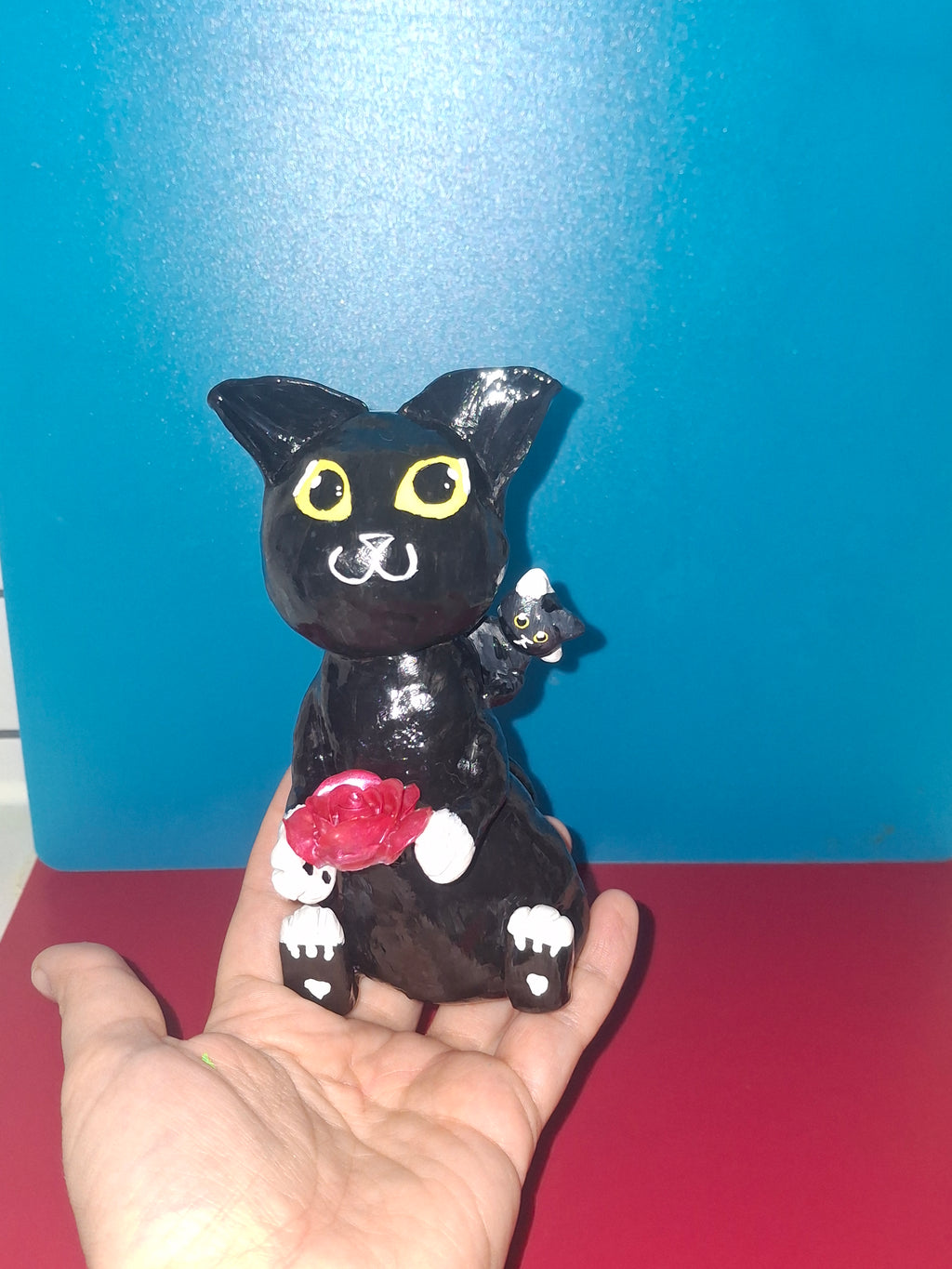 Black cat with baby cat